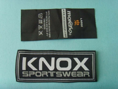 High density black center folded woven label